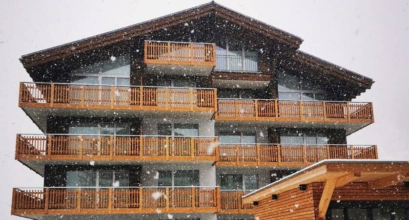 Chalet exterior with multiple private balconies and timber architecture