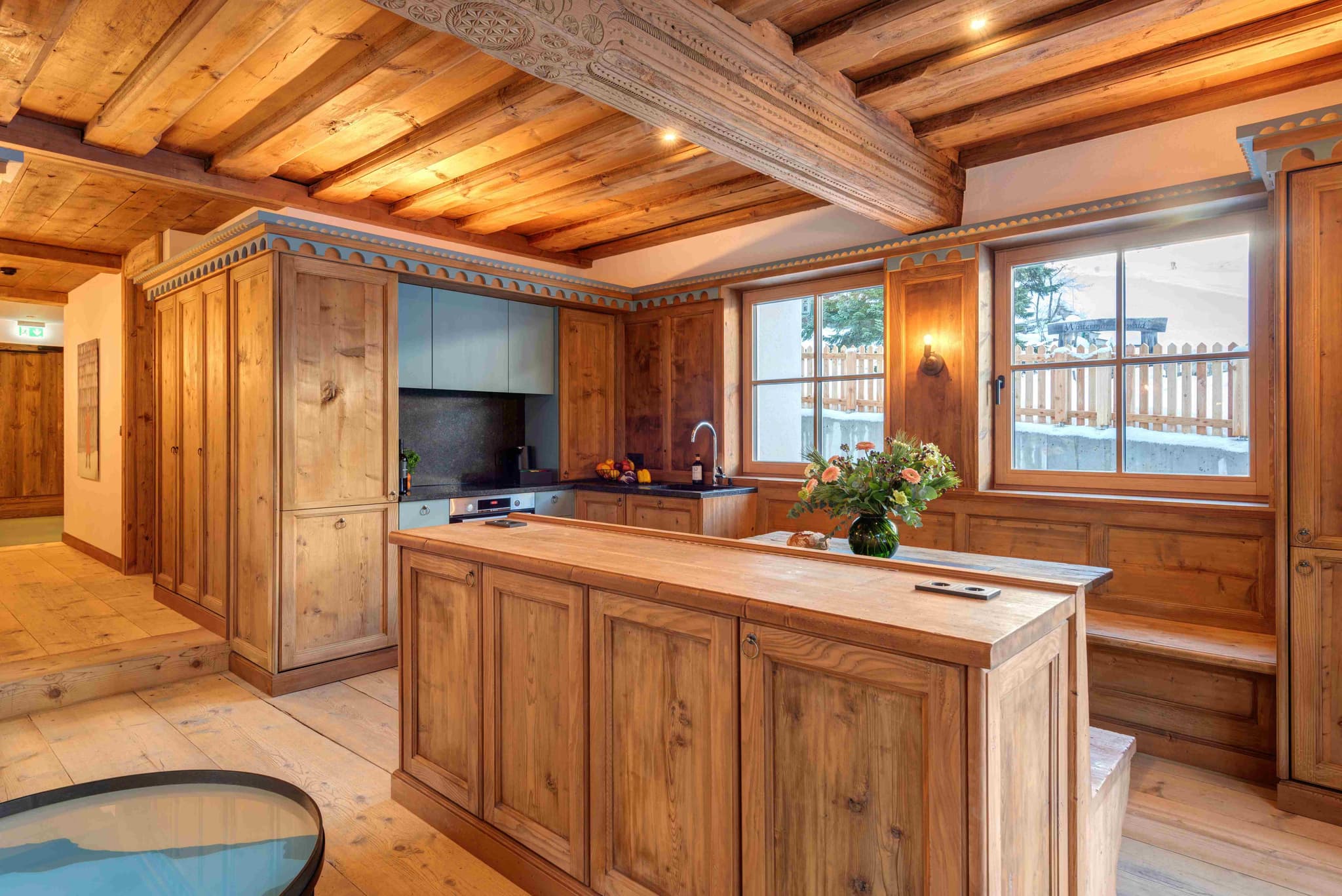 Kitchen with hand-carved timber ceilings and integrated breakfast nook