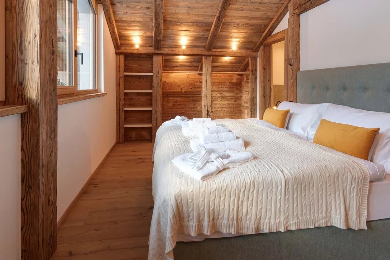 Bedroom with king bed and built-in timber shelving