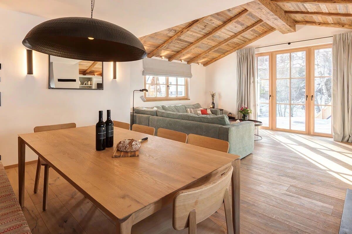 Open-plan dining area with vaulted timber ceiling and terrace access