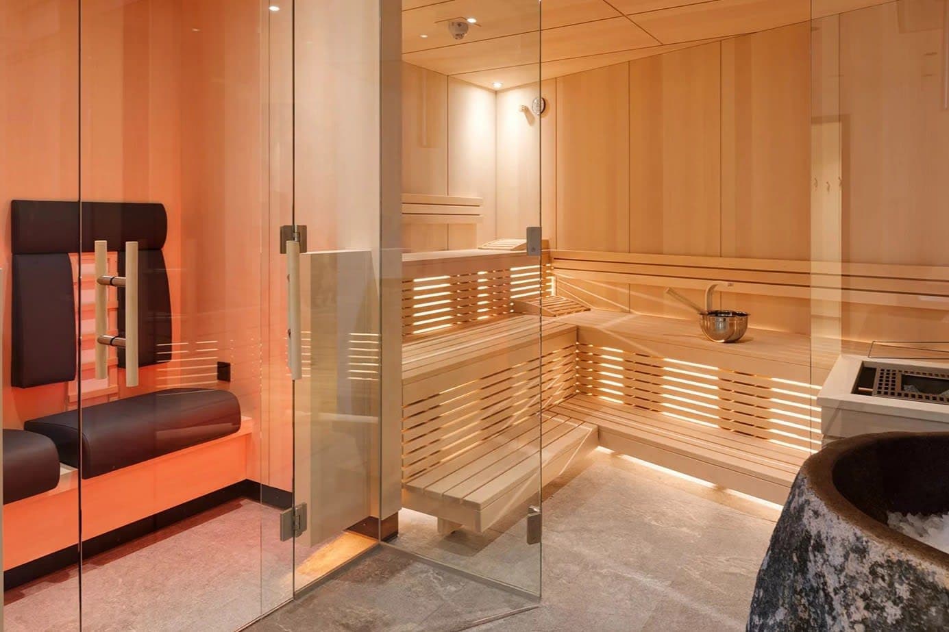Private sauna with multi-level cedar seating and integrated infrared heating panels