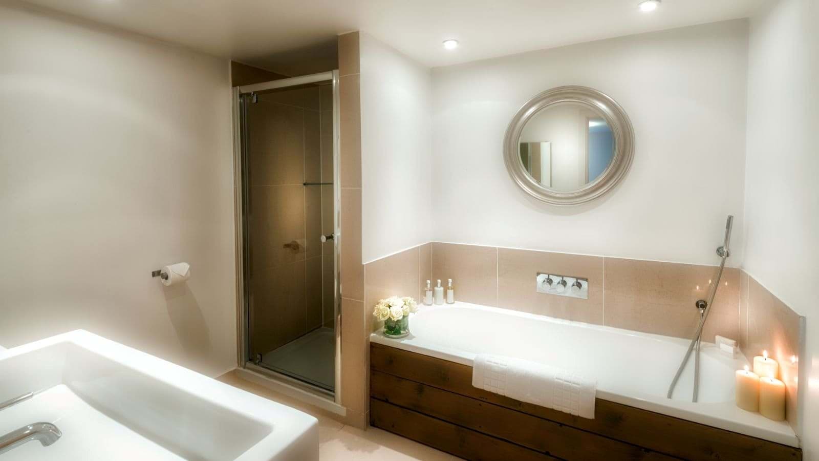 Bathroom with soaking tub, handheld sprayer, and separate walk-in shower