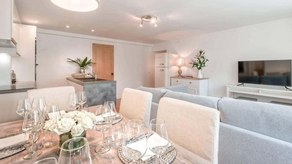 Open-plan living area with retro Smeg refrigerator and dining for 6