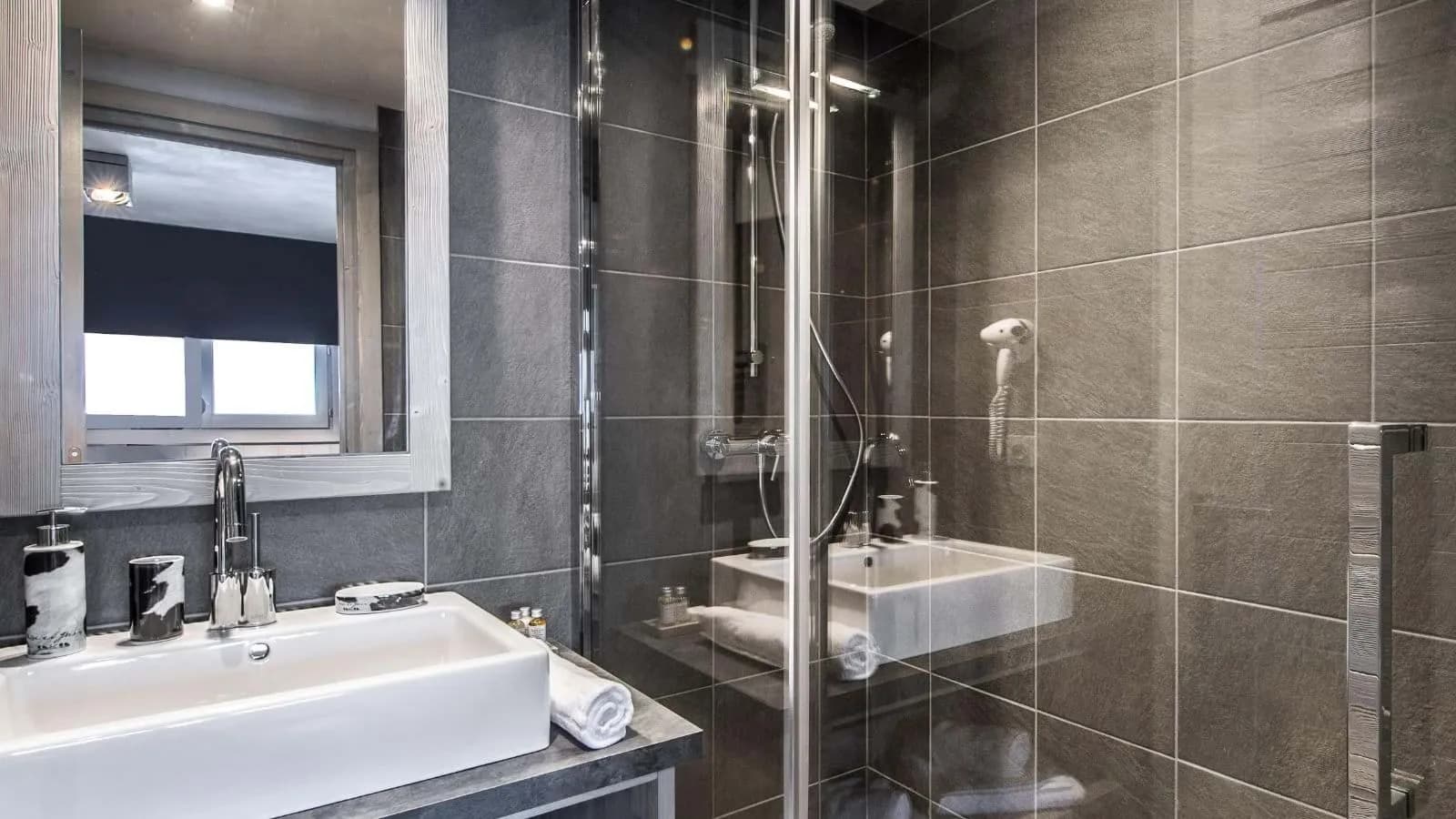 En-suite shower room with a walk-in shower and wall-mounted hairdryer