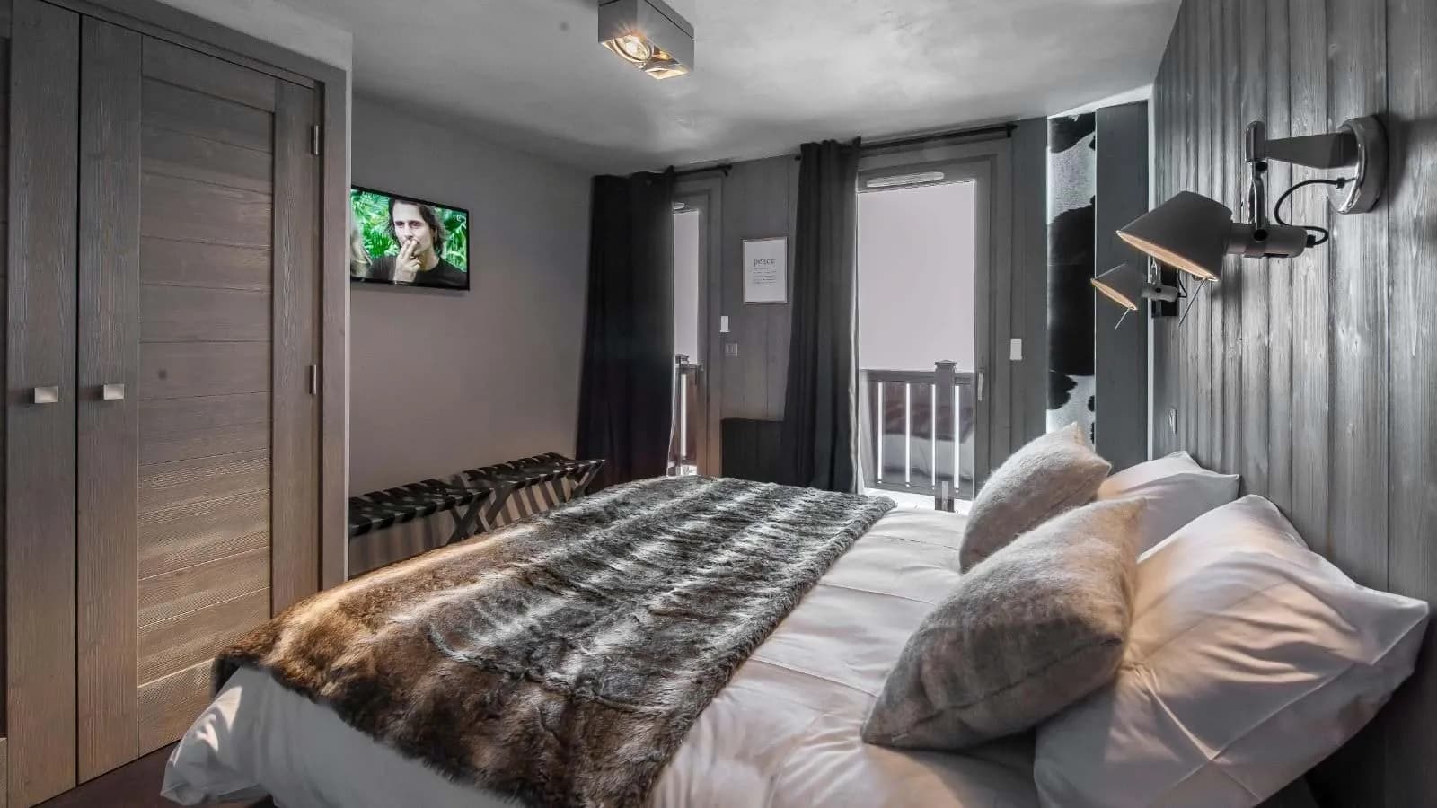 Double bedroom with balcony access, a television and wardrobe