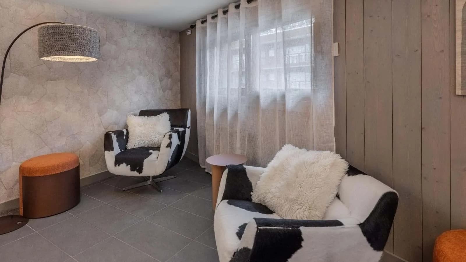 Lounge seating area with cowhide armchairs