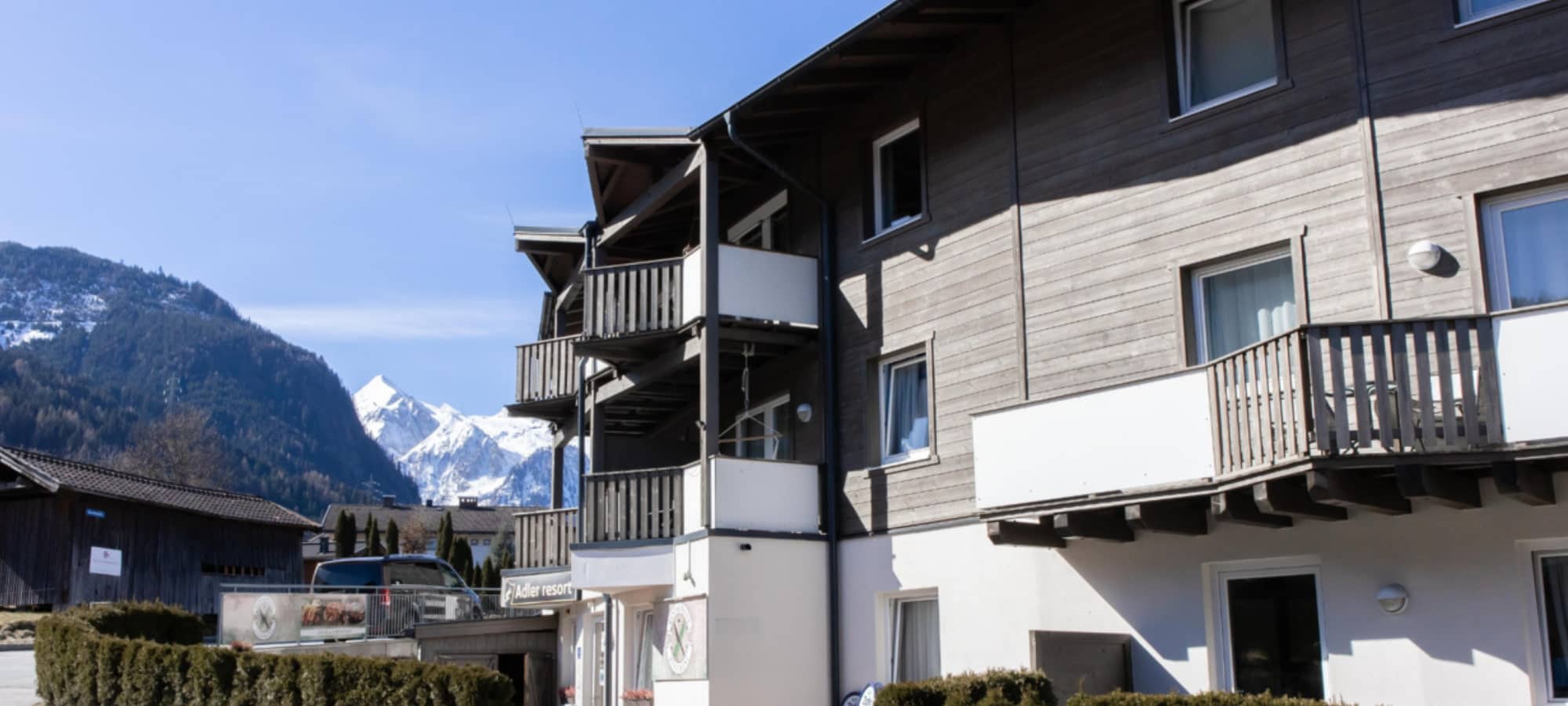 Building exterior featuring private balconies with views of the Austrian Alps