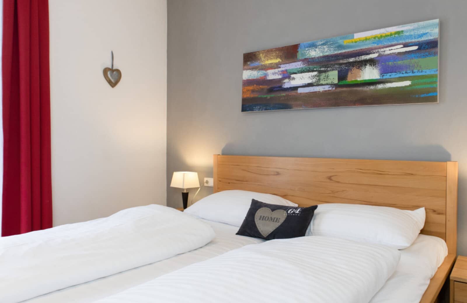 Guest bedroom with queen bed and blackout curtains
