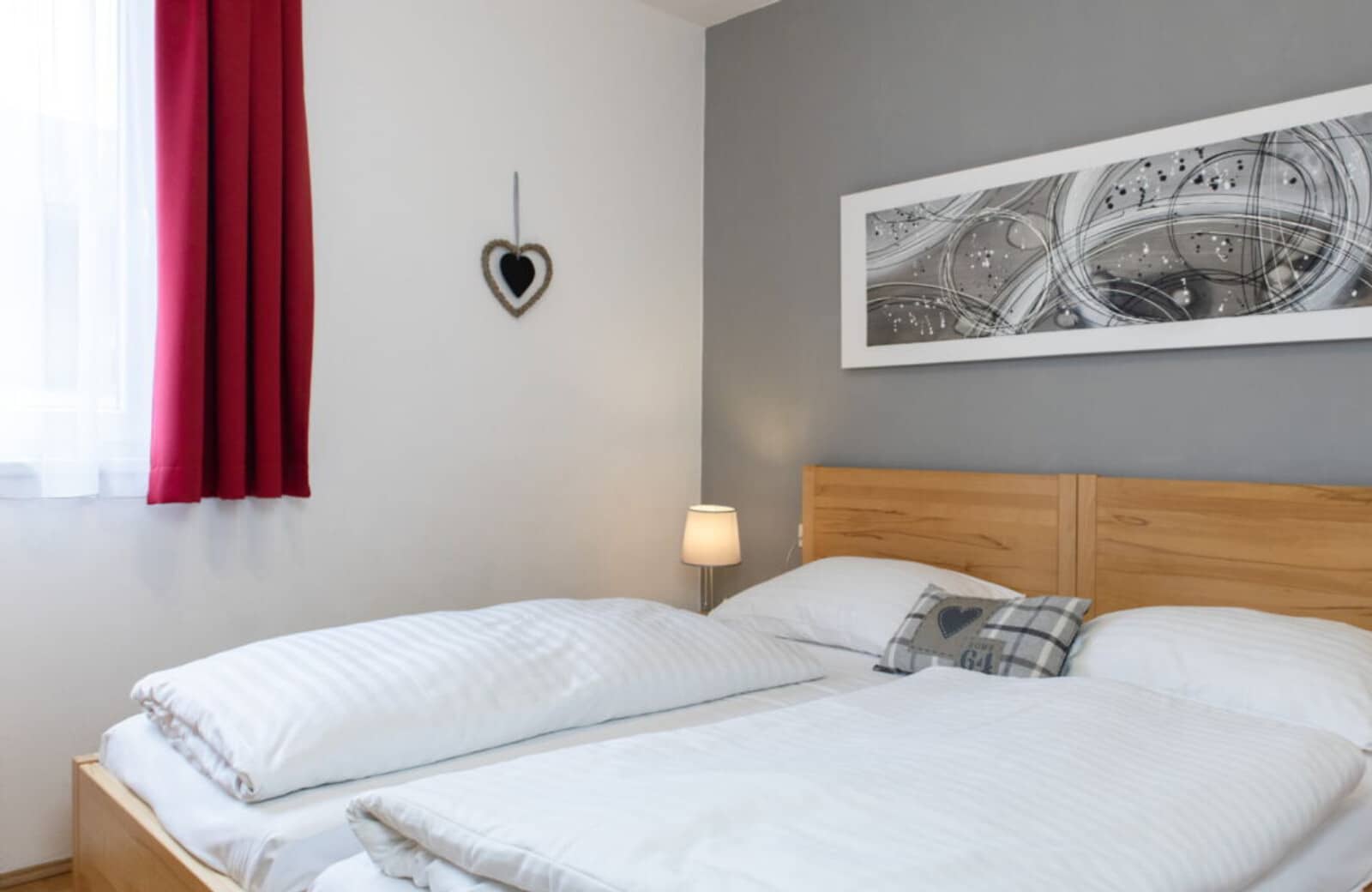 Guest bedroom with two twin mattresses on a shared timber frame