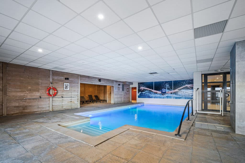 Indoor pool with step entry and poolside shower