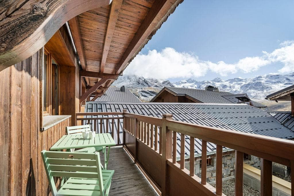 Private balcony with seating for two and snow-capped mountain views