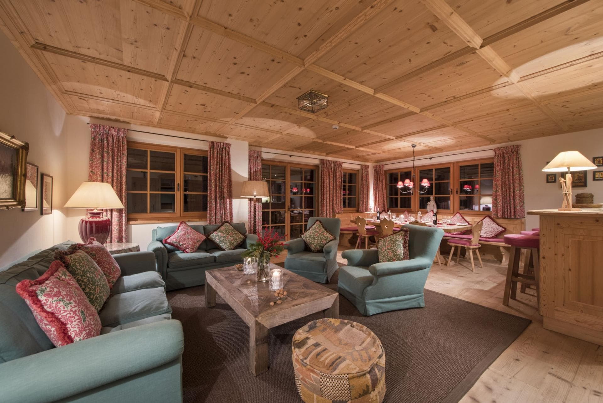 Open-plan living area featuring coffered wood ceilings and dining seating for 10