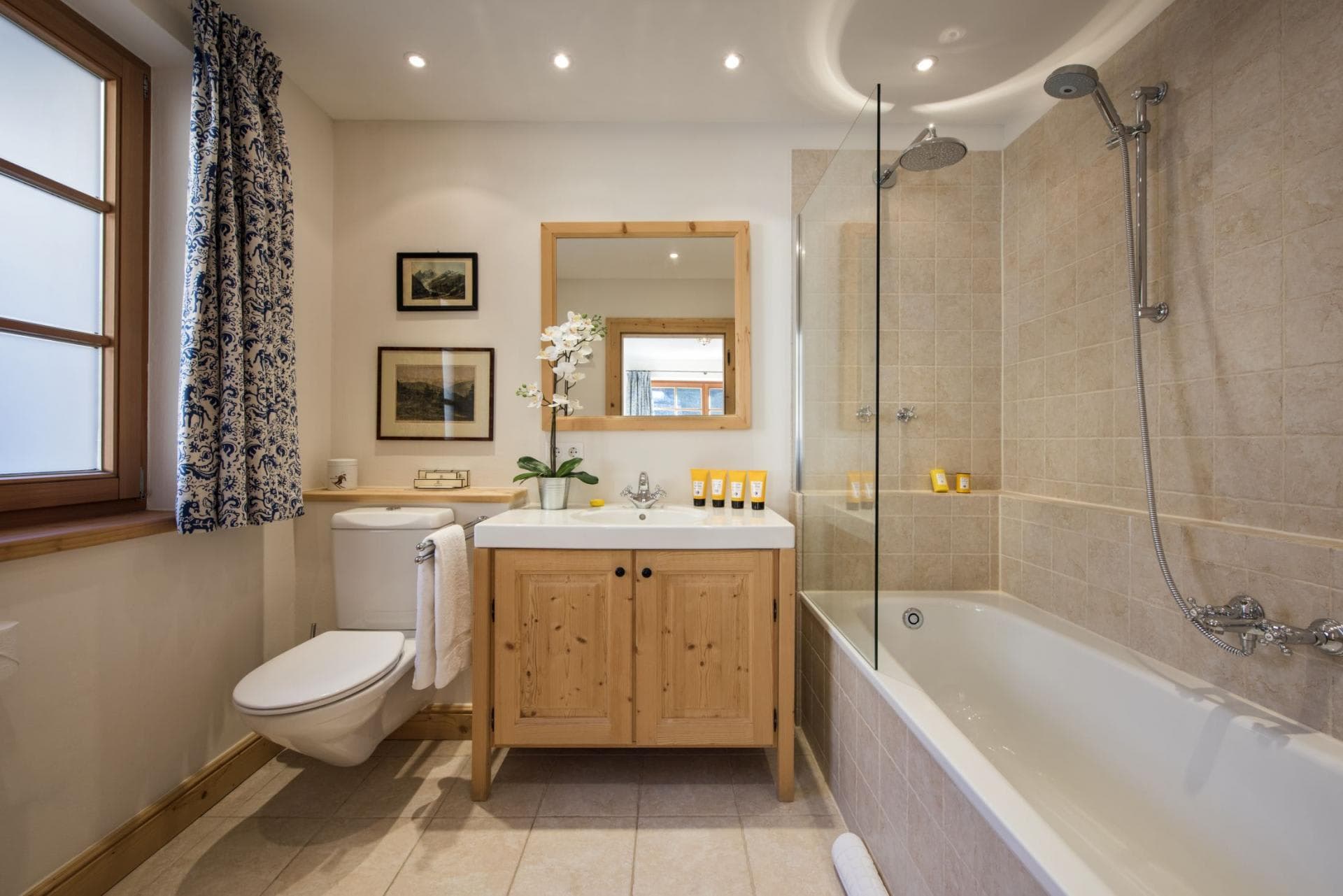 Bathroom featuring soaking tub with rainfall and handheld shower heads