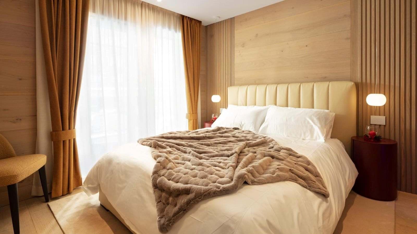 Guest bedroom with king bed and floor-to-ceiling blackout curtains