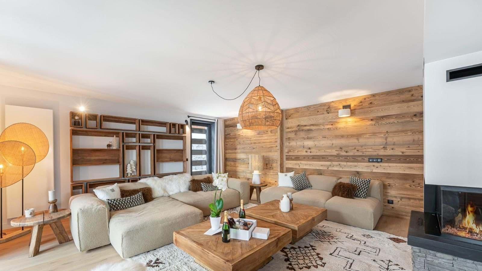 Living room with wood-paneled accent wall, gas fireplace, and modular seating for 8+