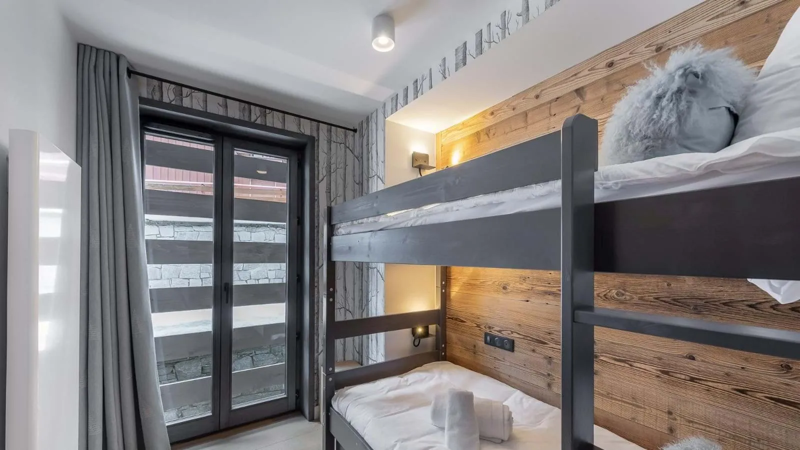 Two-berth bunk sleeping nook beneath a timber ceiling