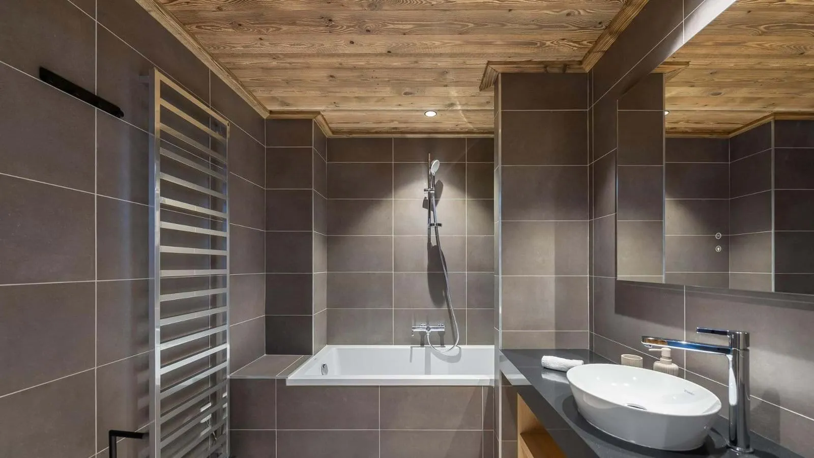 Bathroom with a bathtub and heated towel rail