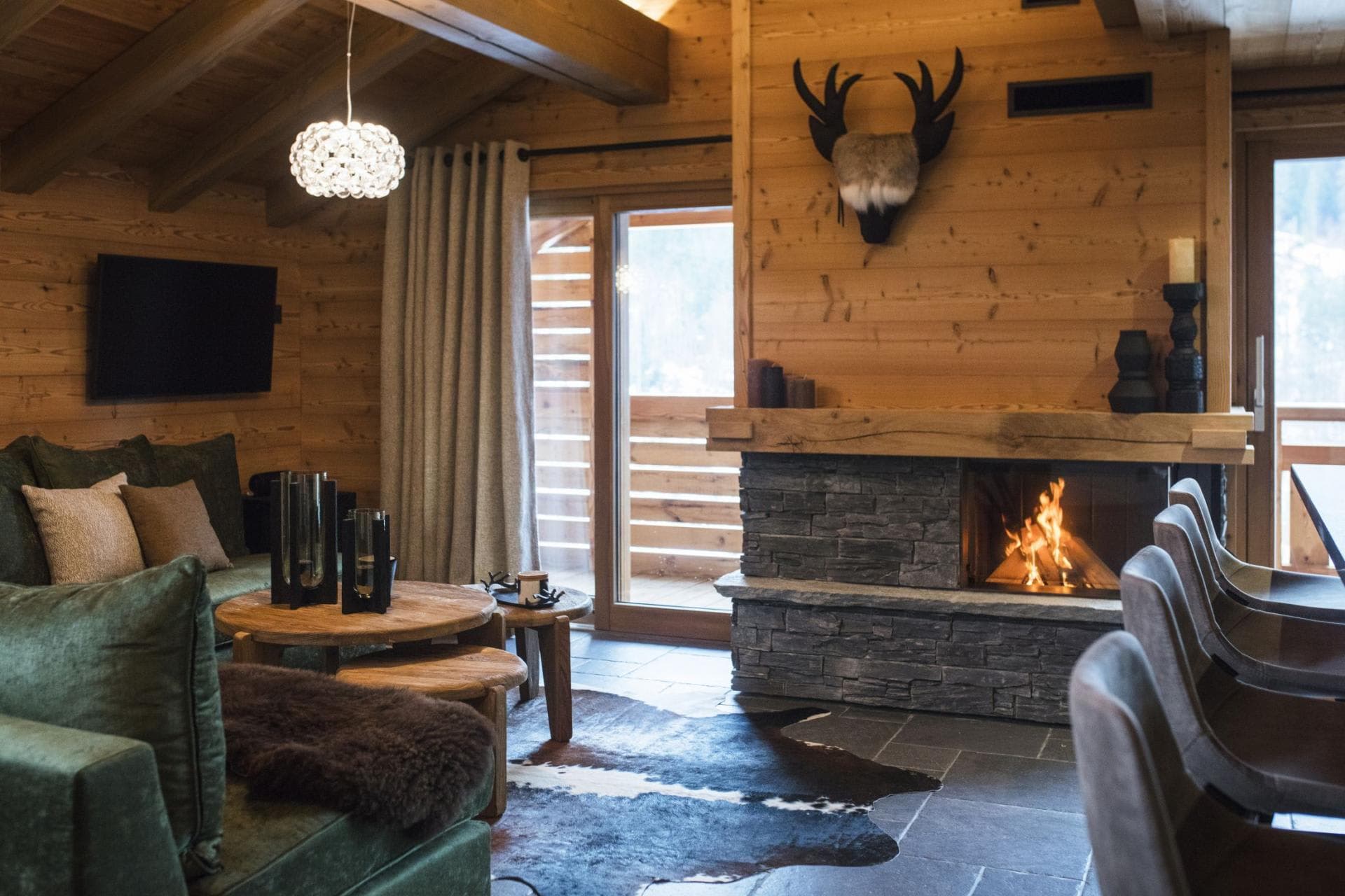 Living area with wood-burning fireplace and balcony access