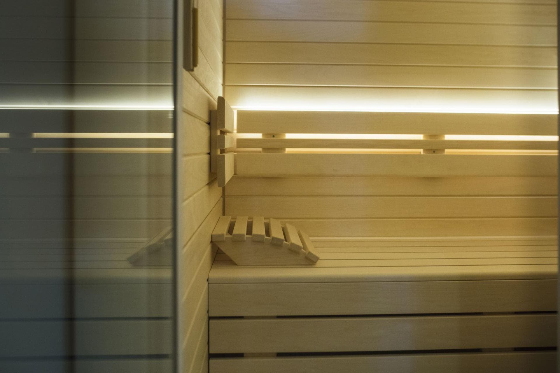 Private cedar sauna with integrated LED lighting and wooden headrest