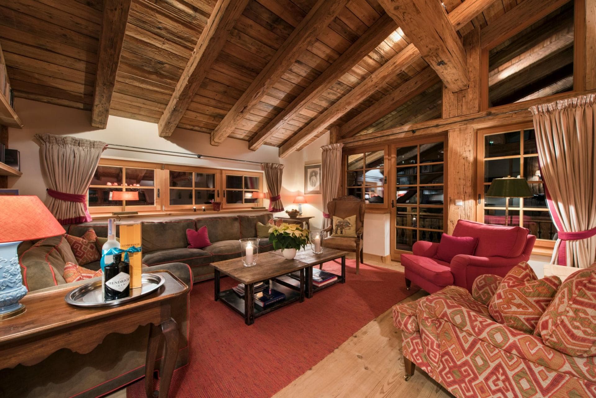 Living area with reclaimed wood beams and balcony access