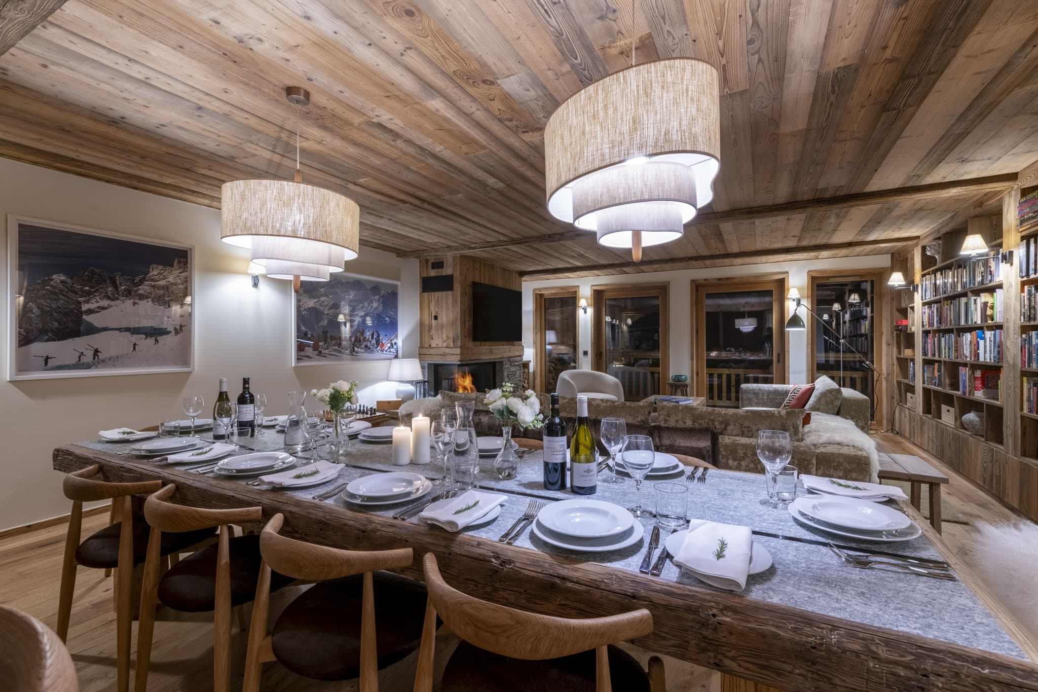 Dining area with seating for 10 near wood-burning fireplace and library