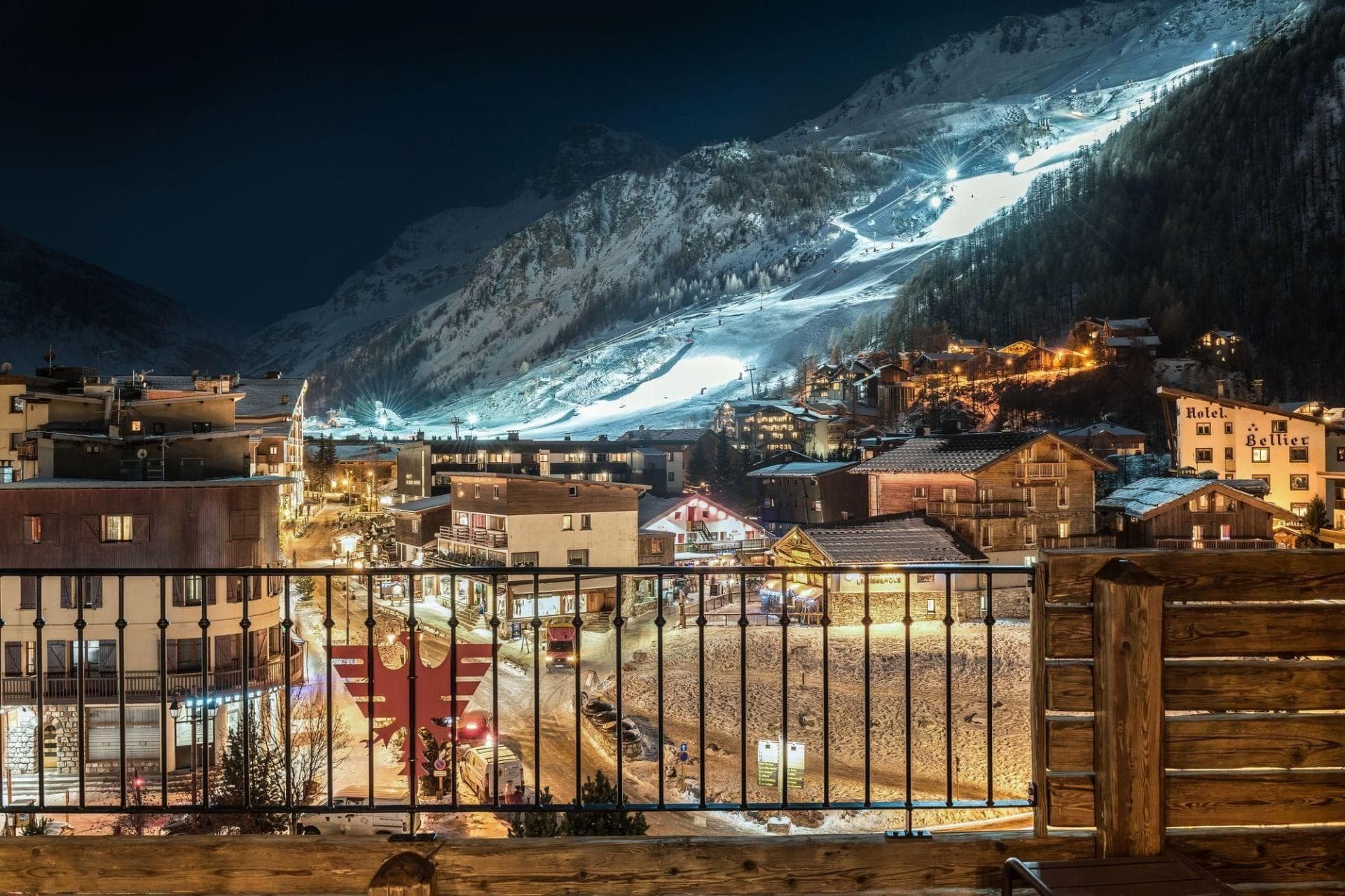 Private balcony with village views and lit night-skiing slopes