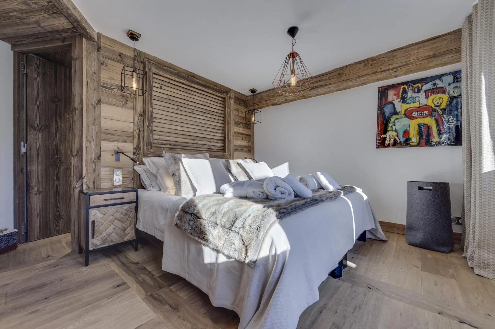 Double bedroom with timber panelling and bedside reading lights