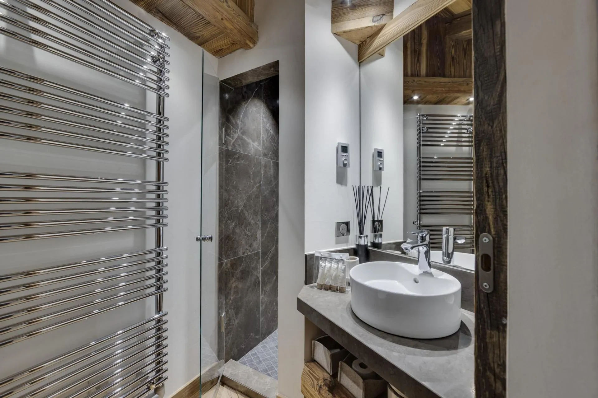 Bathroom featuring heated towel rail and walk-in stone shower