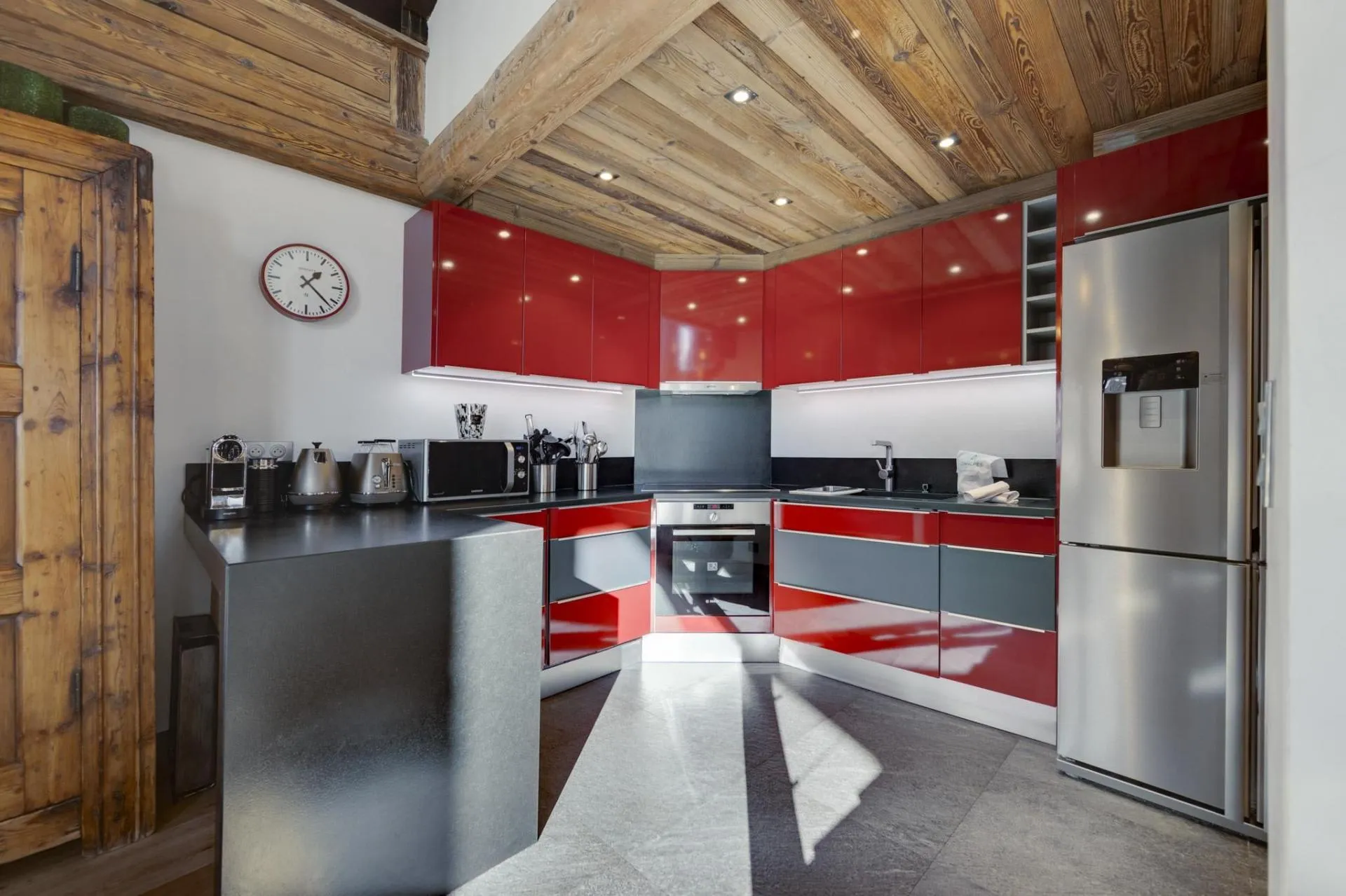 Kitchen with Nespresso machine, full-size refrigerator, and under-cabinet lighting