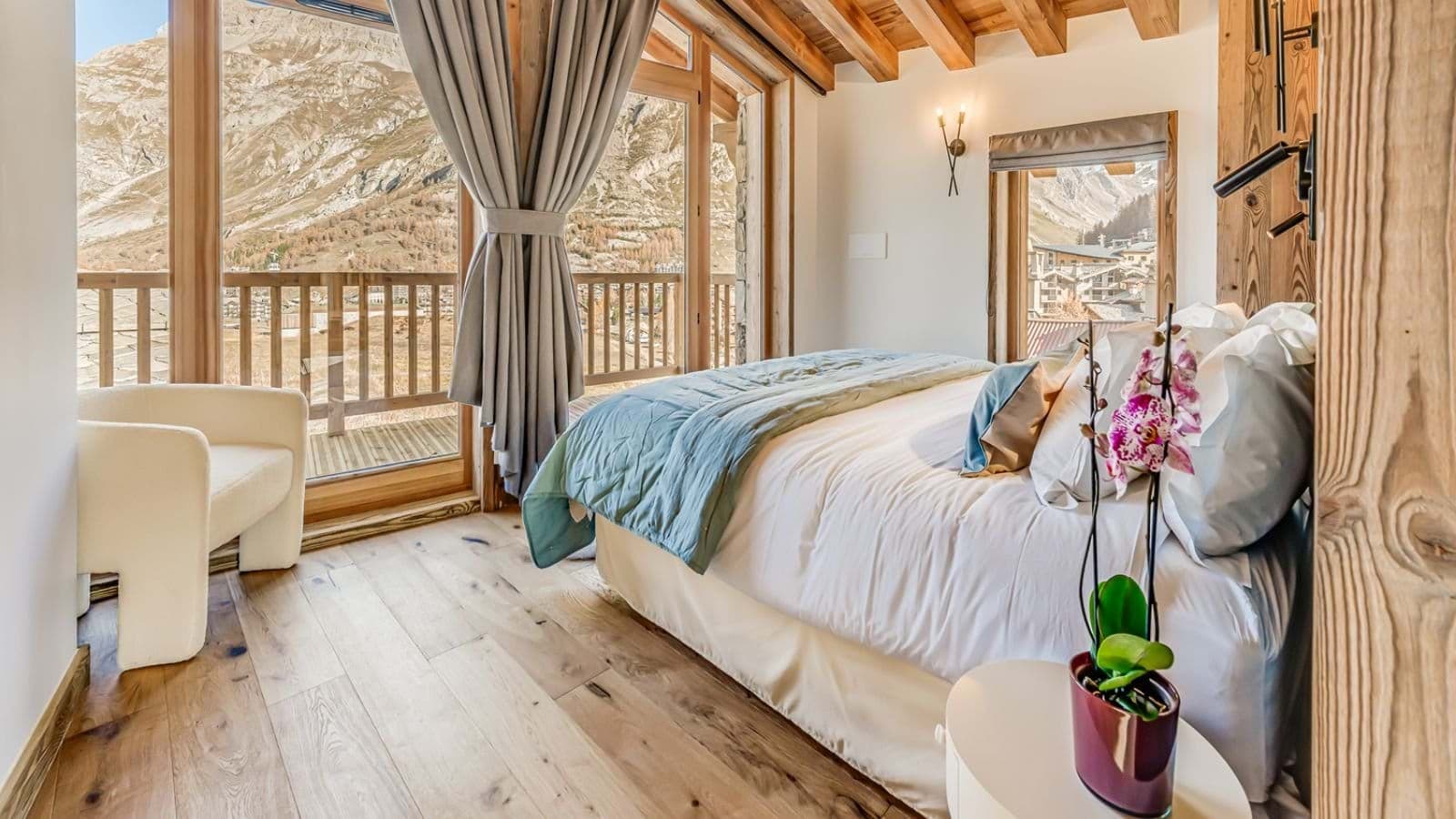 Bedroom with mountain views and private balcony access