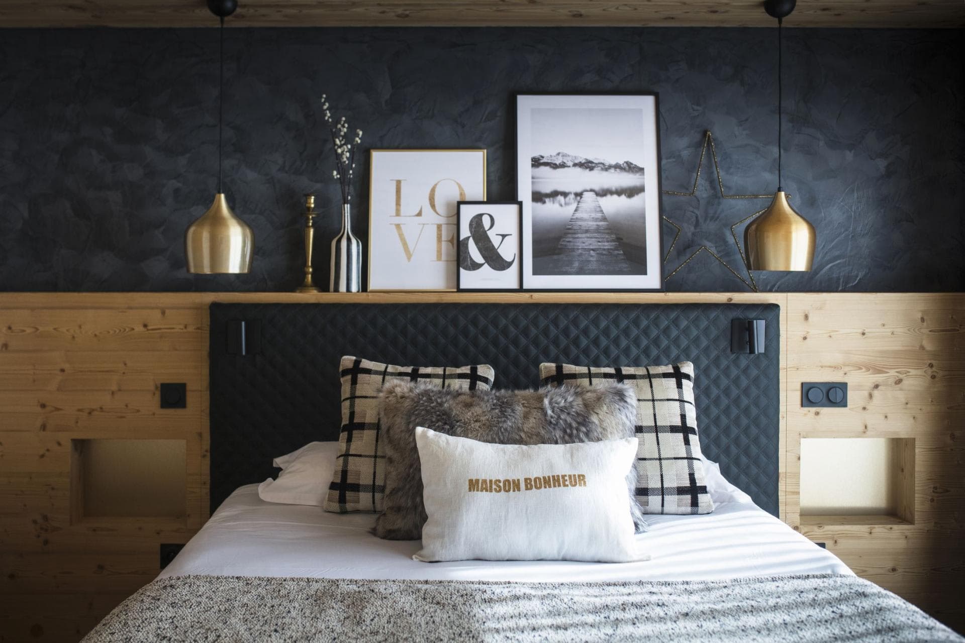 Bedroom featuring integrated bedside lighting and built-in shelving within timber headboard