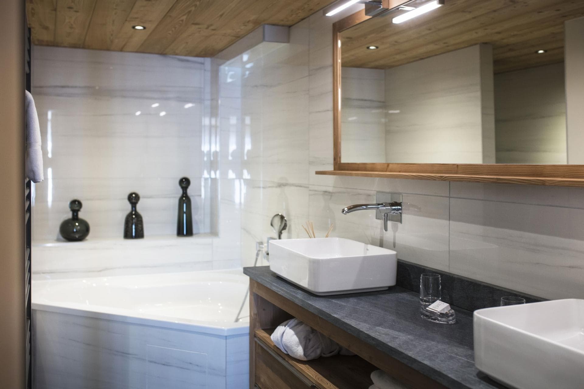 Bathroom with dual vessel sinks and corner soaking tub