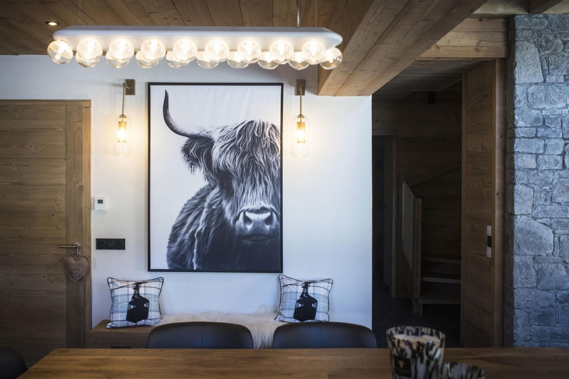 Dining area featuring bench seating and adjacent staircase to upper level