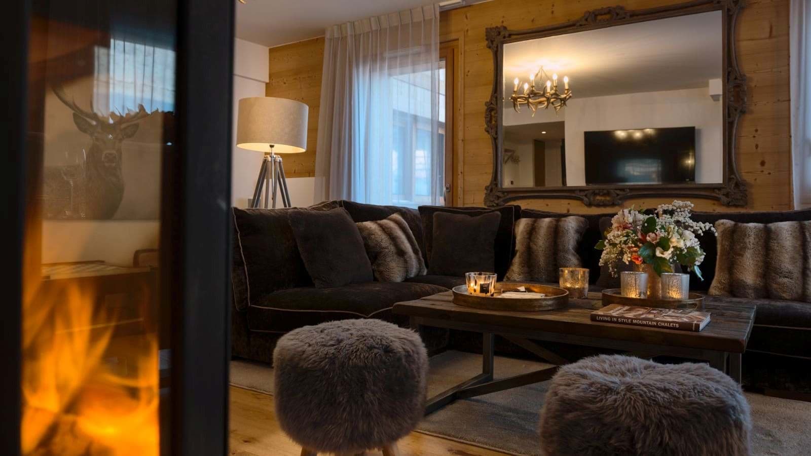 Open-plan lounge with sectional seating and a wood-burning stove