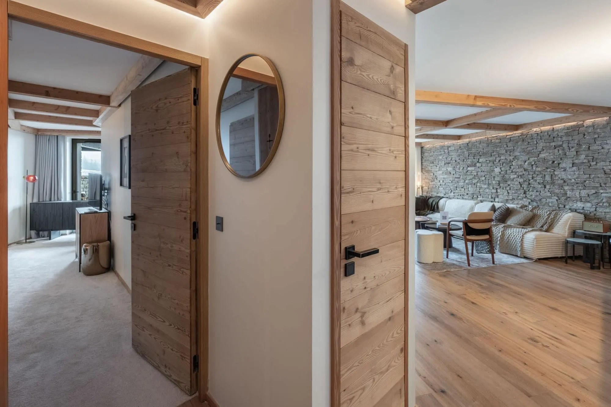 Hallway connecting the sleeping and living areas with timber doors