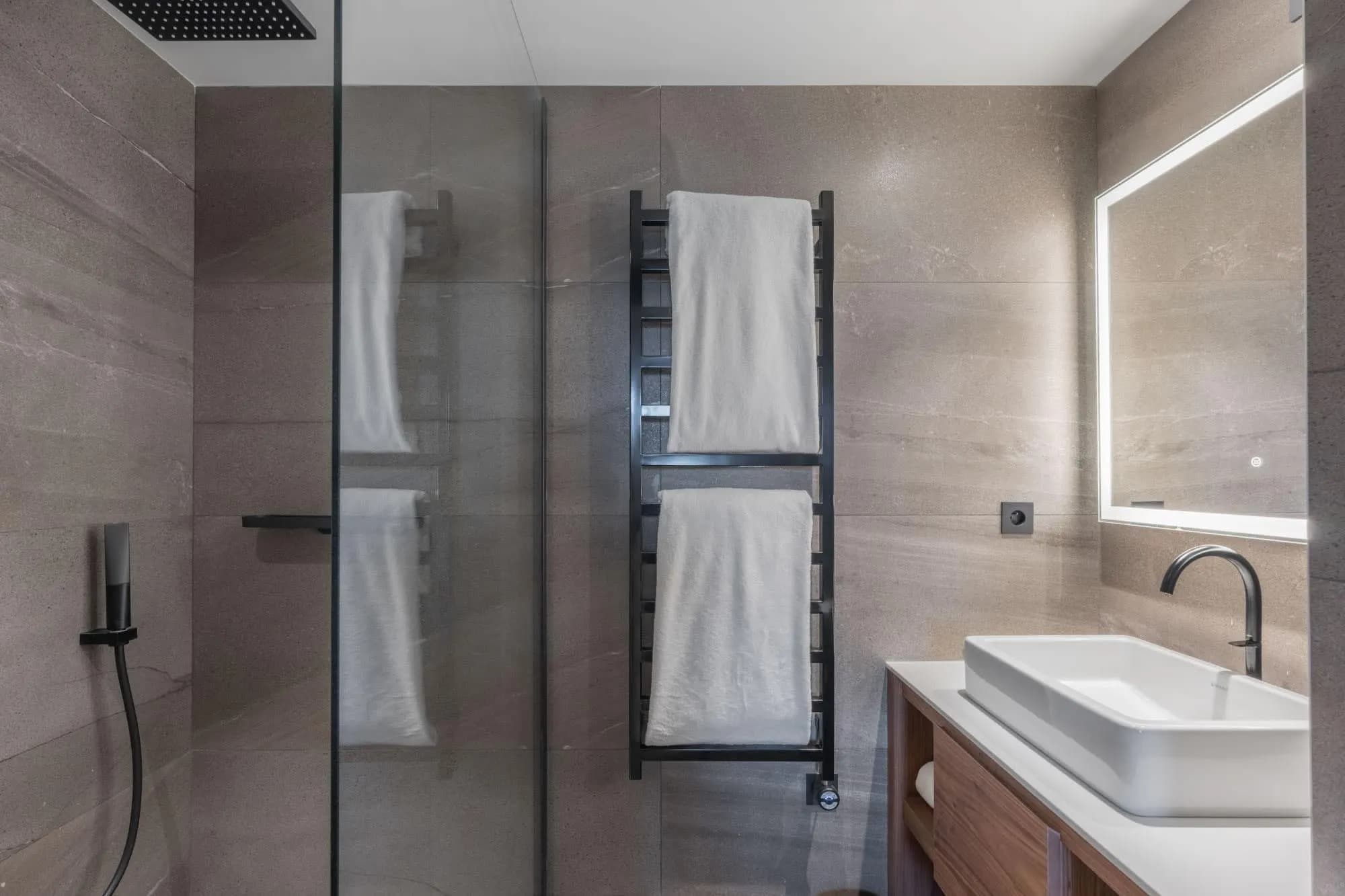 En-suite shower room with walk-in shower and backlit mirror
