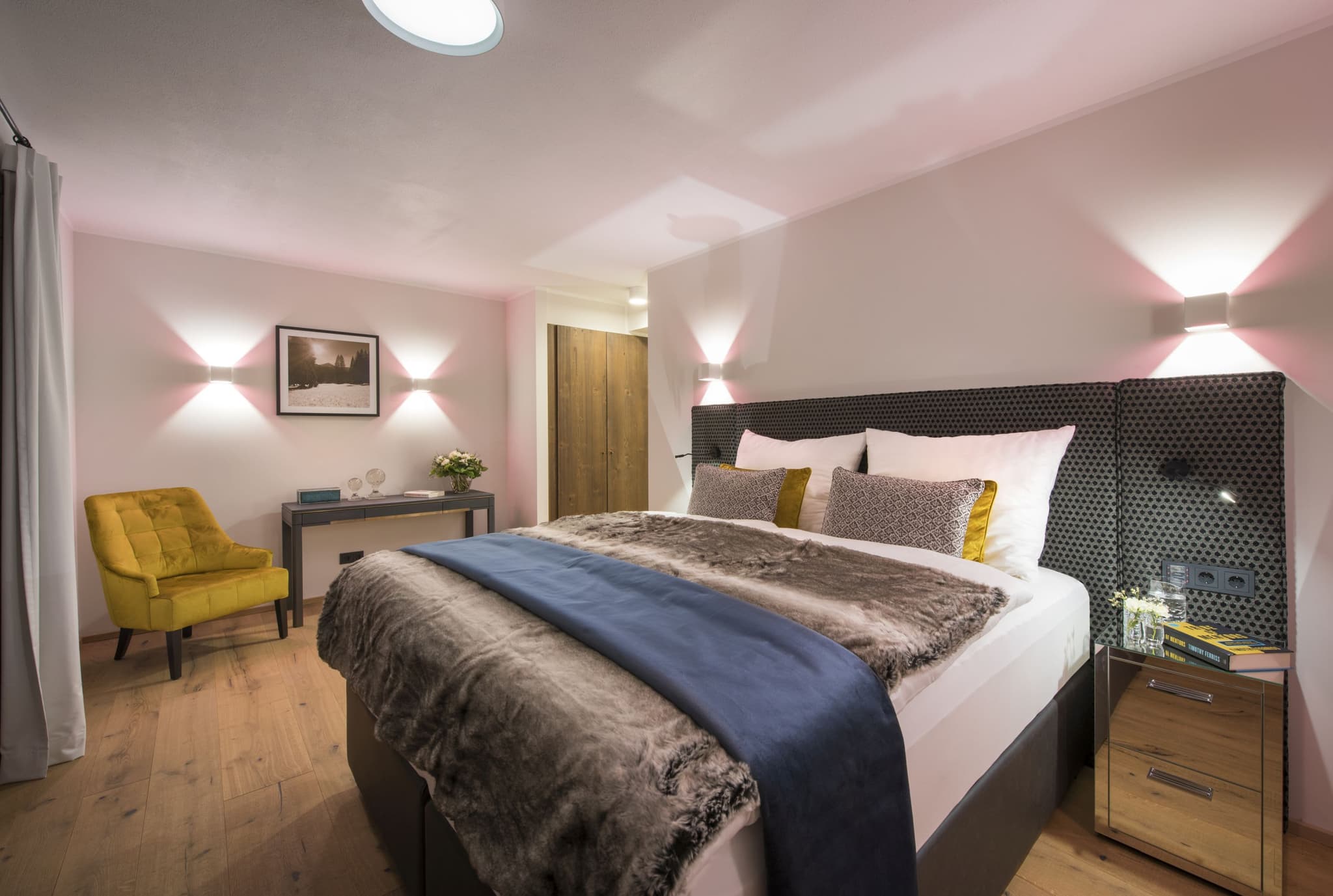 Bedroom with king bed, reading chair, and built-in closet storage