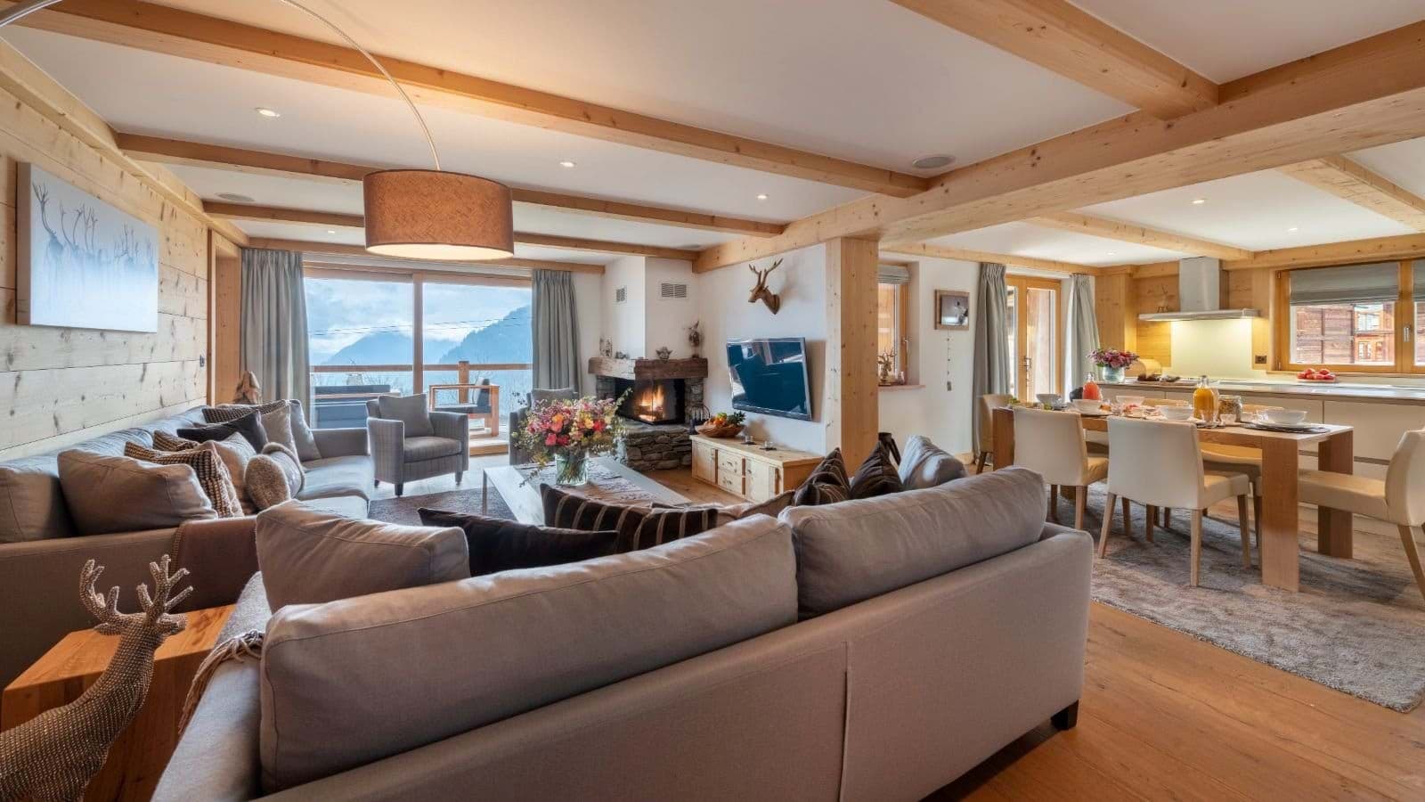 Open living area with stone fireplace and mountain view balcony