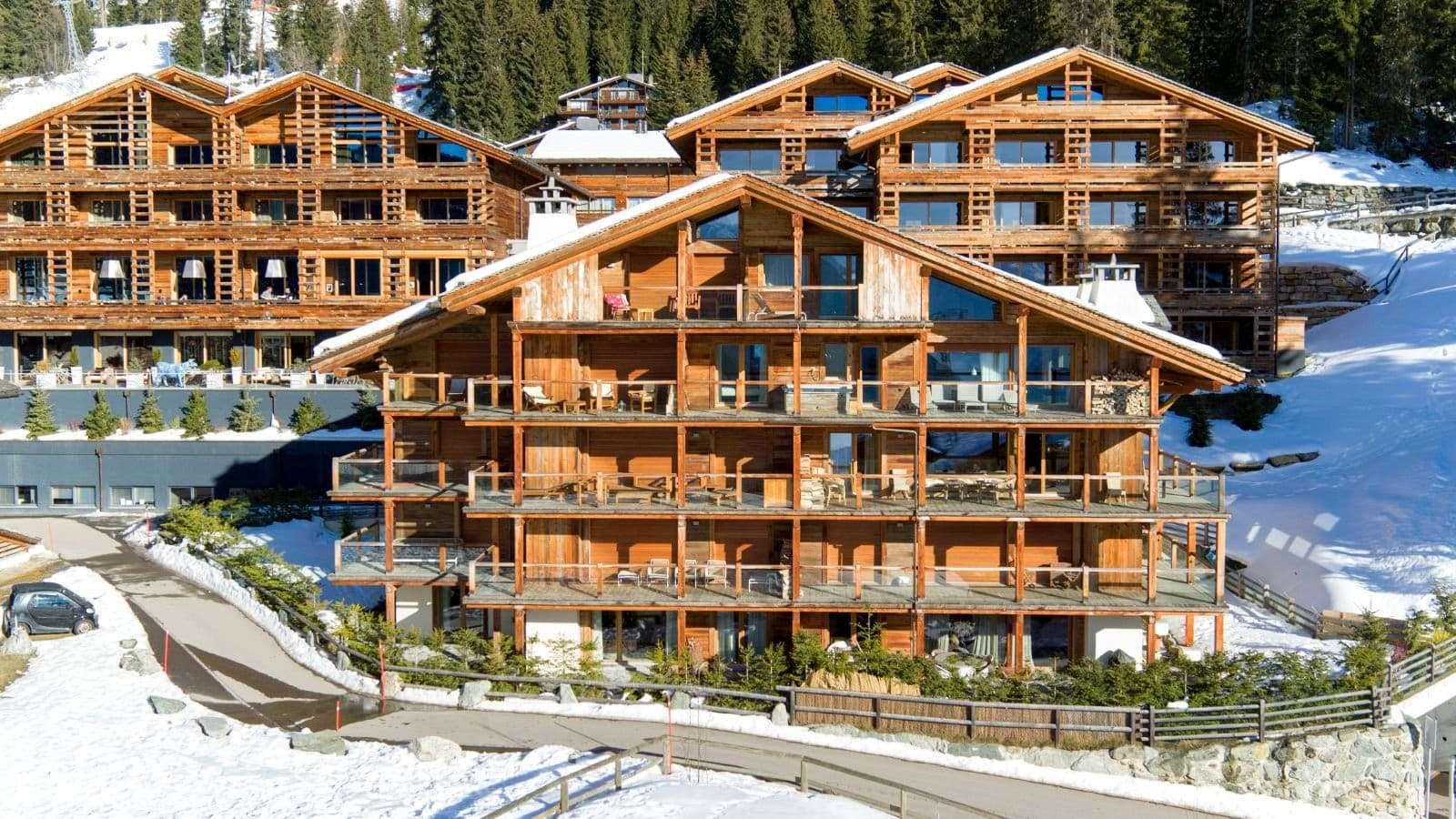 Multi-level timber chalets with private balconies and slope access