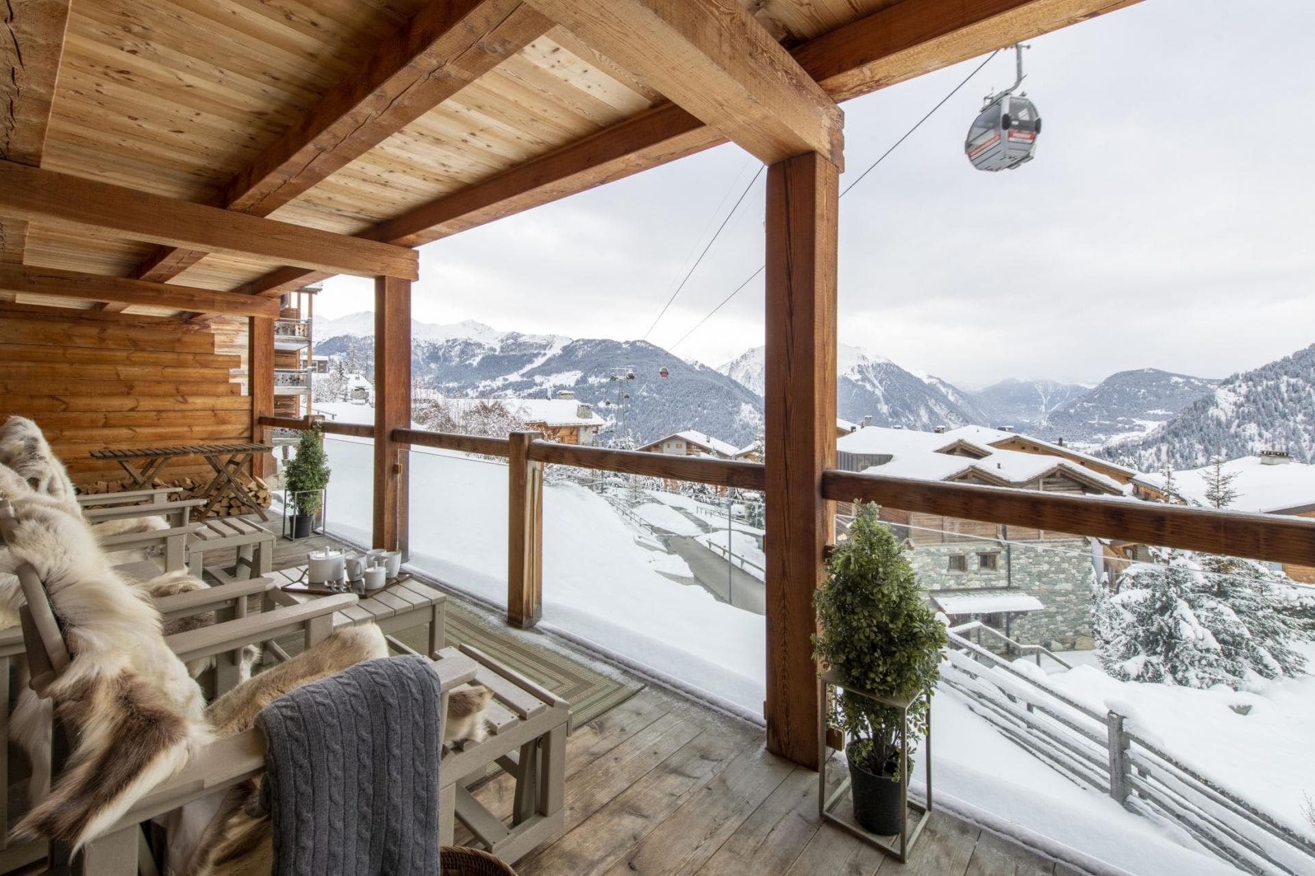 Covered balcony with seating and direct views of the Medran gondola