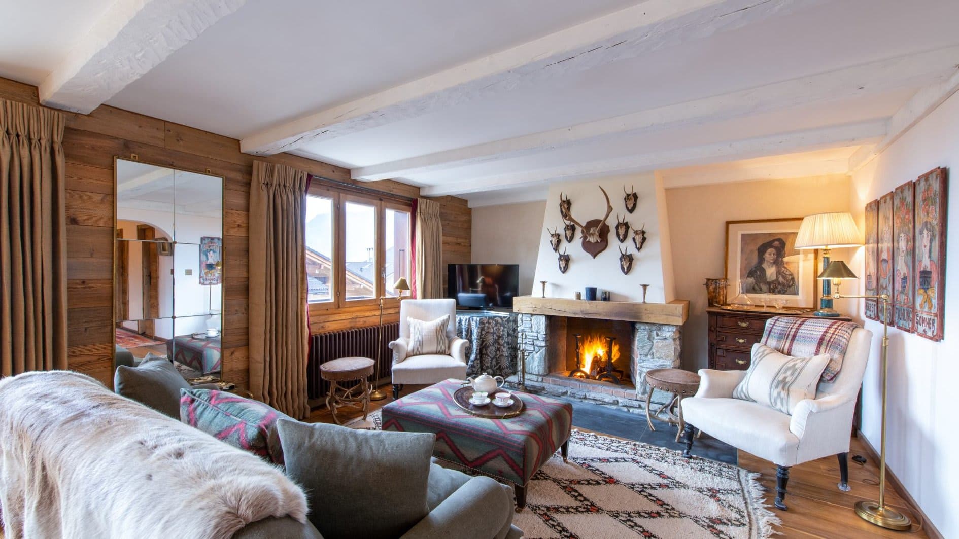 Living room with wood-burning fireplace and exposed ceiling beams
