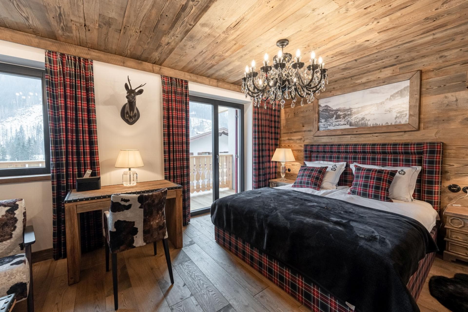 Bedroom with king bed, writing desk, and private balcony access