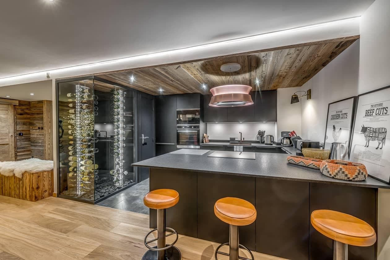 Kitchen island with bar seating and glass-enclosed wine cellar
