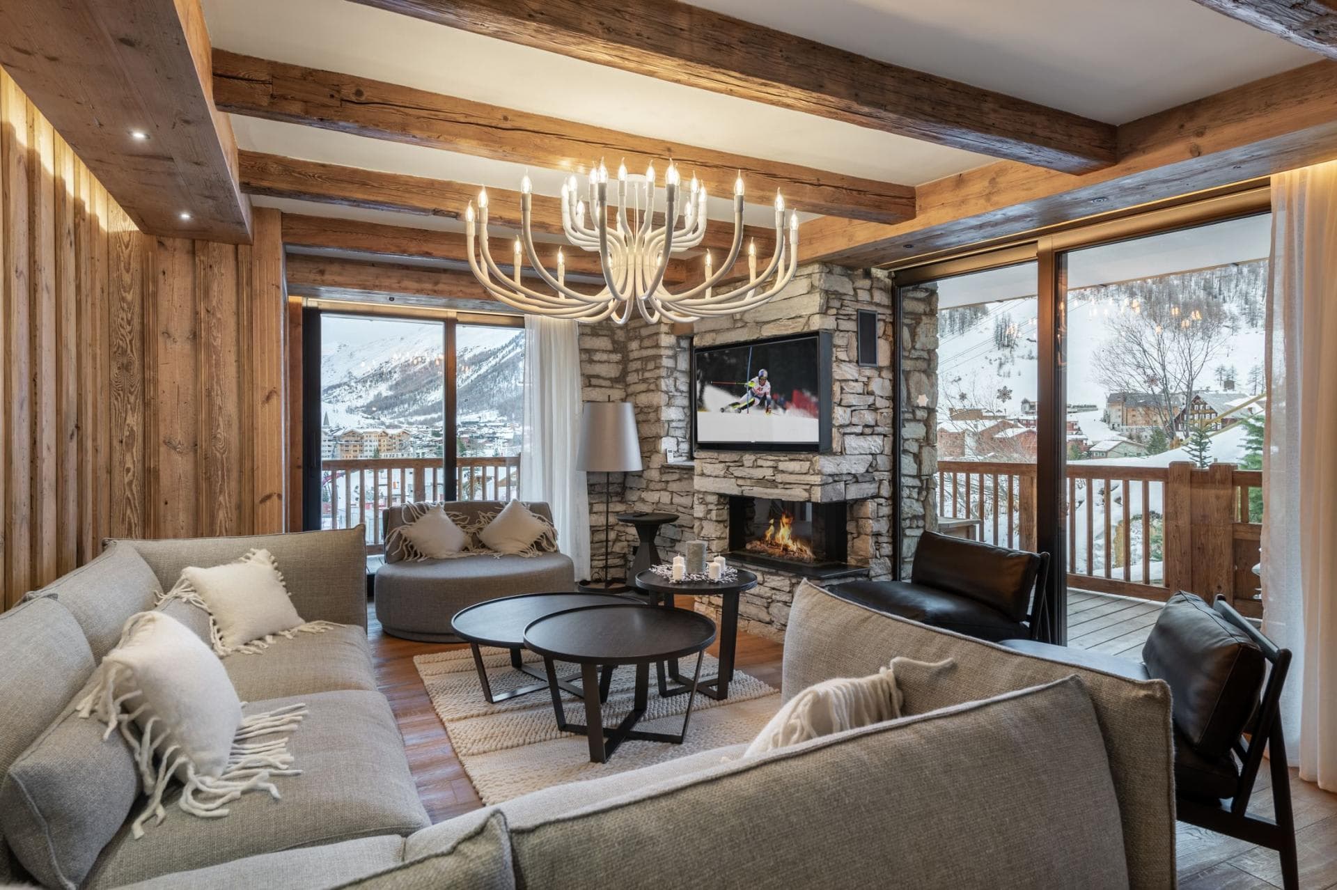 Living area with wood-burning fireplace and mountain-view balcony