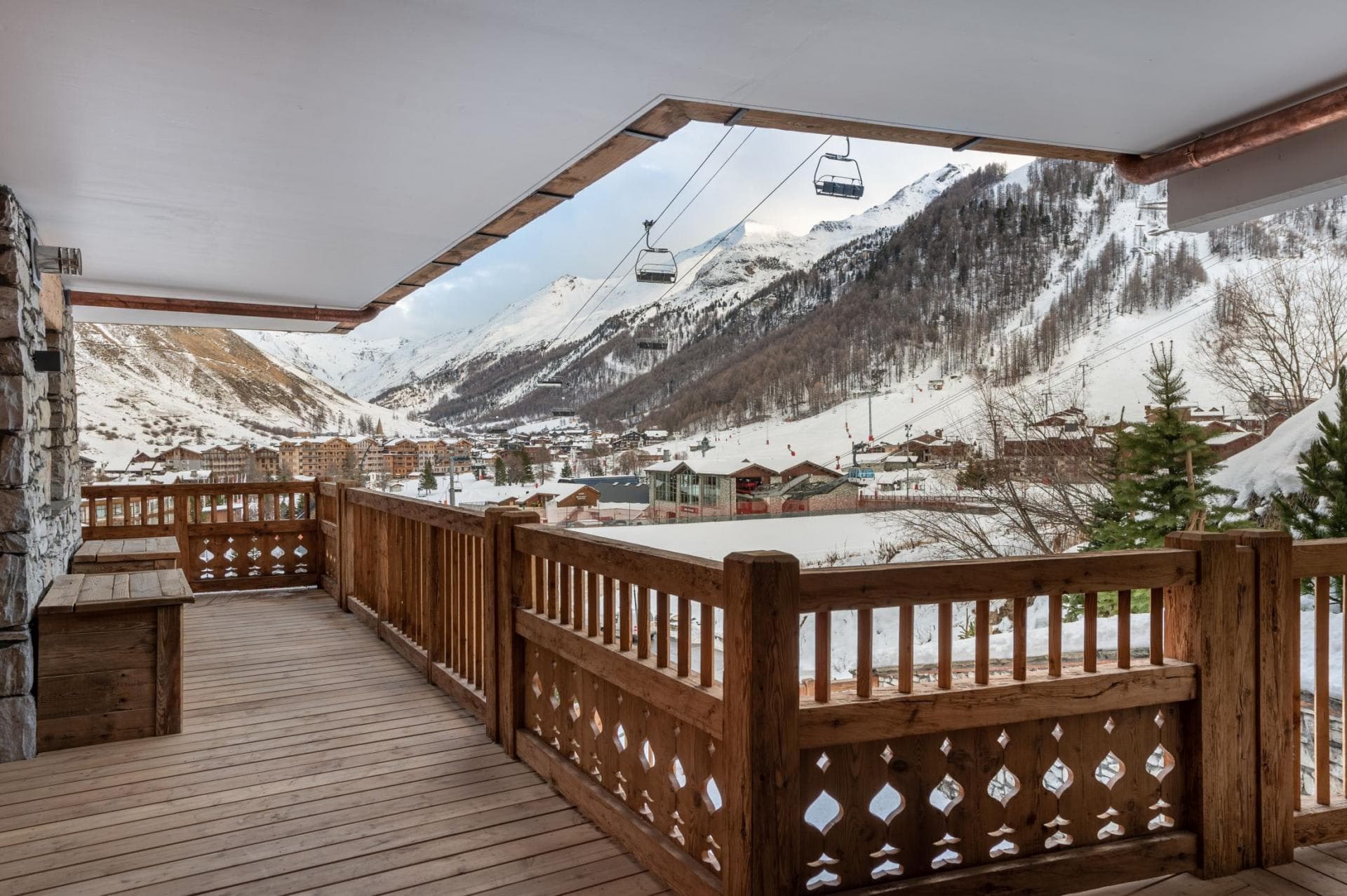 Covered wooden balcony with direct views of the ski lifts