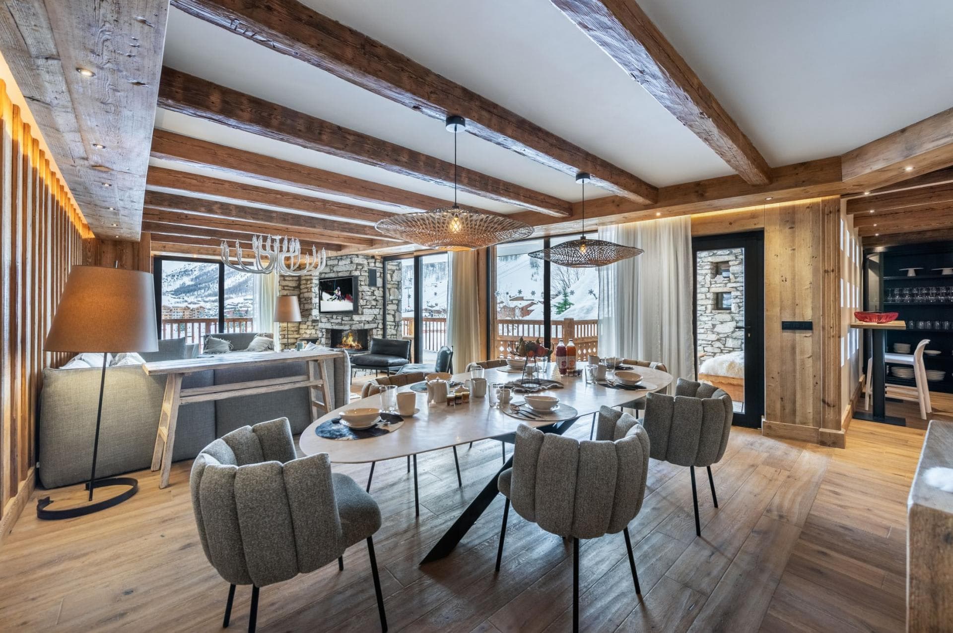 Open-plan dining area seats 8; reclaimed wood beams and mountain views