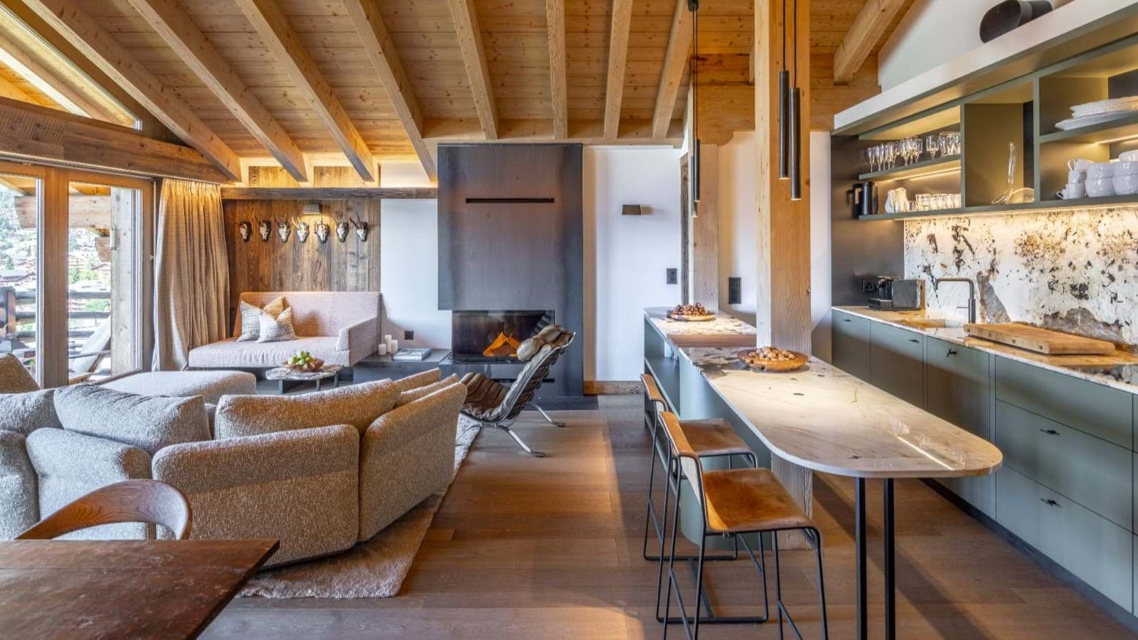 Open living area with wood-burning fireplace and breakfast bar seating for 3
