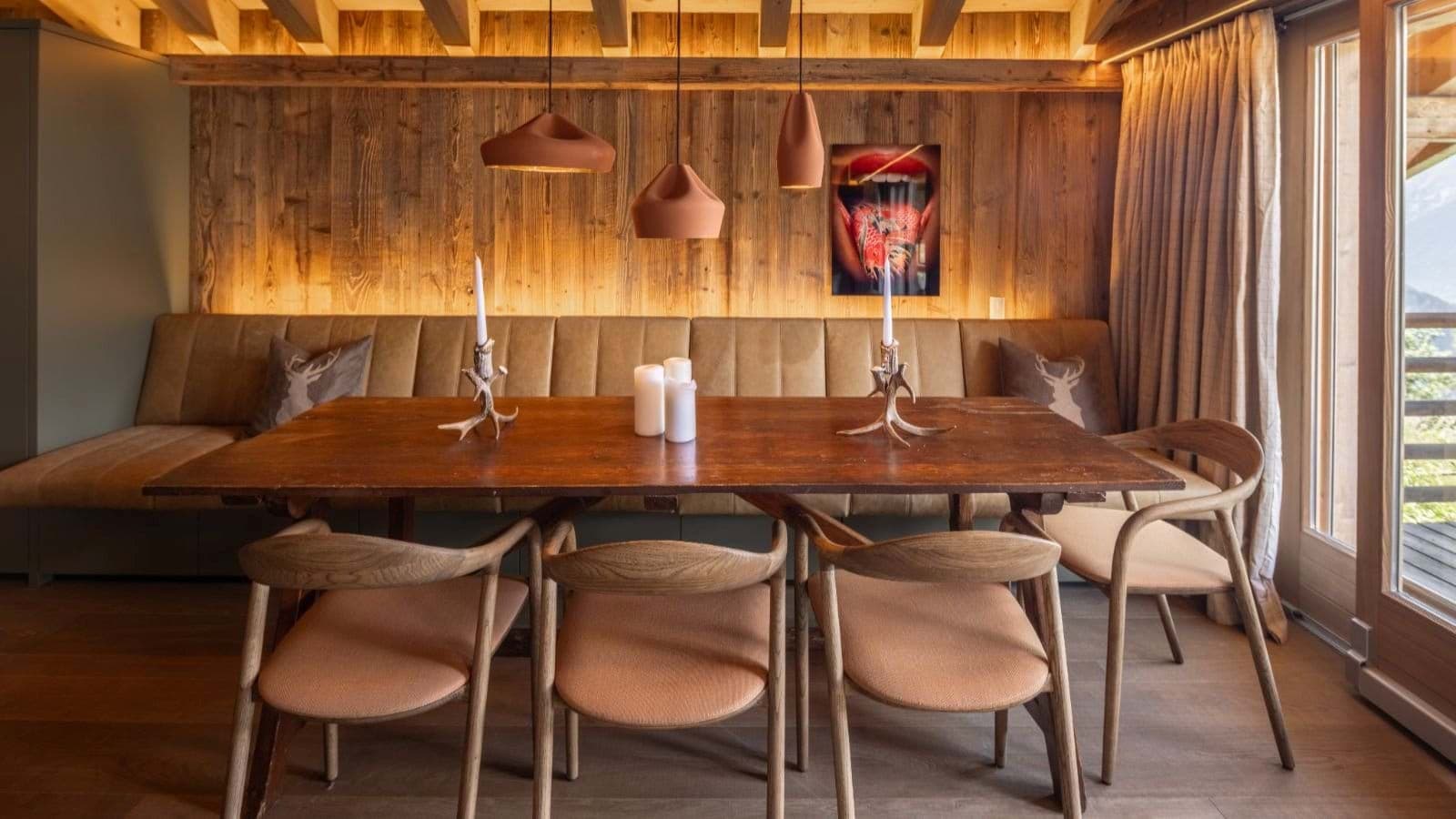 Dining area seats 8 with banquette and balcony access