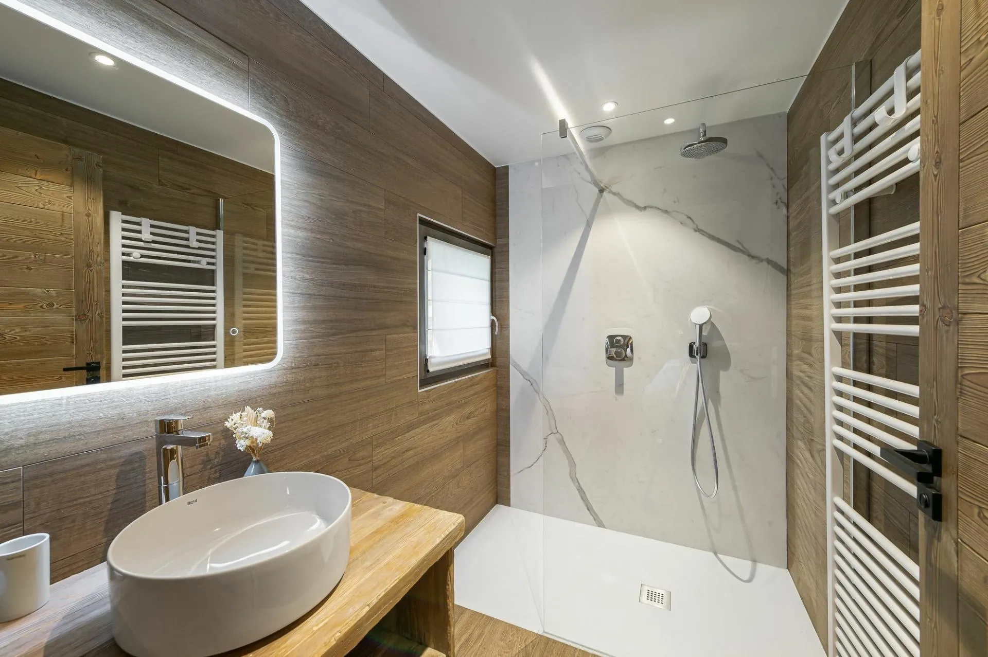 En-suite shower room with single basin and heated towel rail