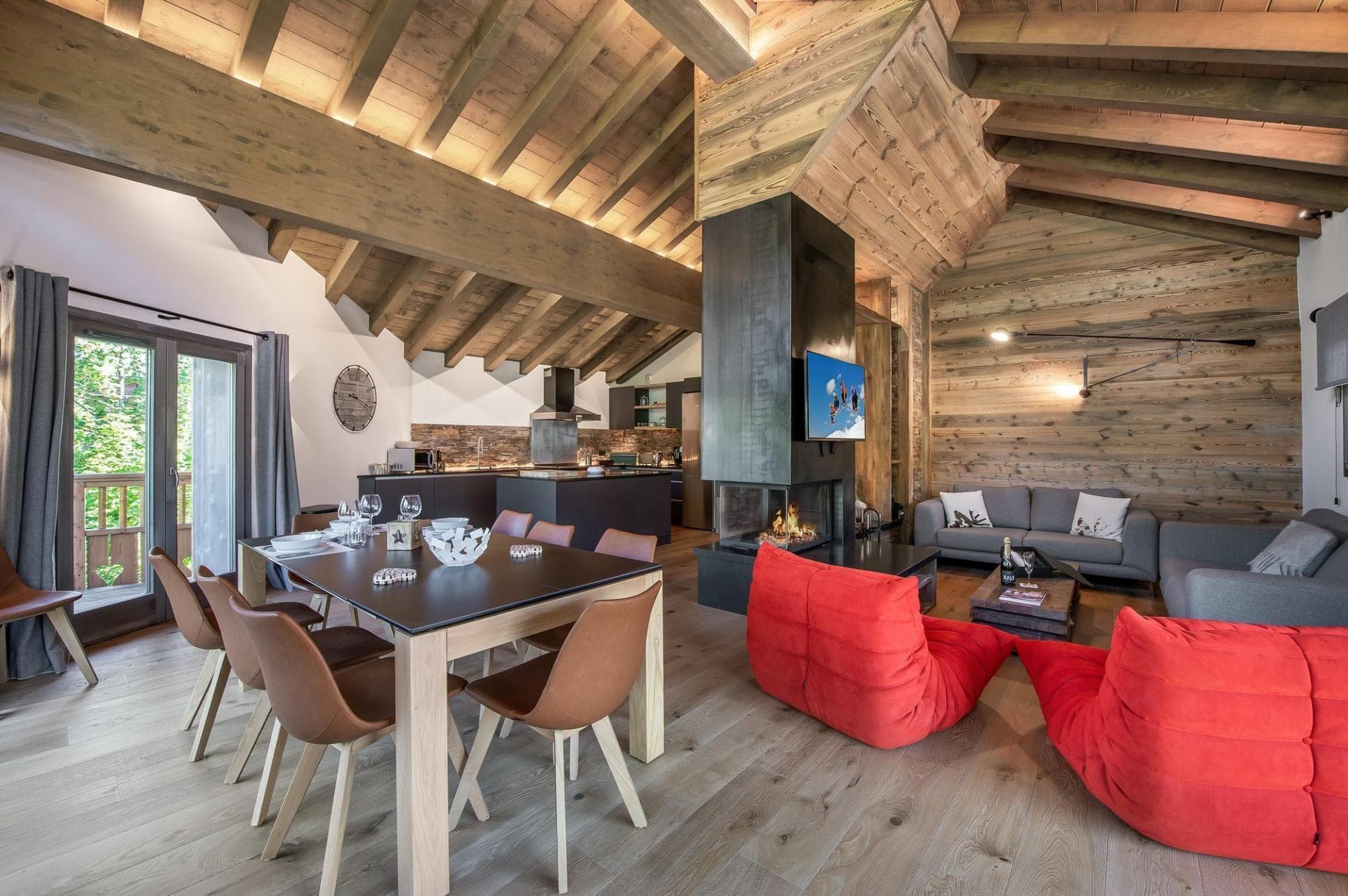 Dining and living area arranged around the central wood fireplace